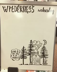 a white board with writing on it and trees