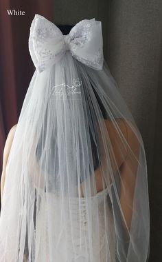 the veil is white and has a large bow on it