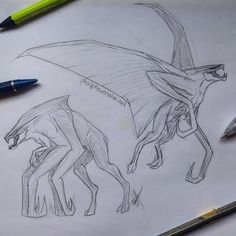 a drawing of two dinosaurs on paper with pencils