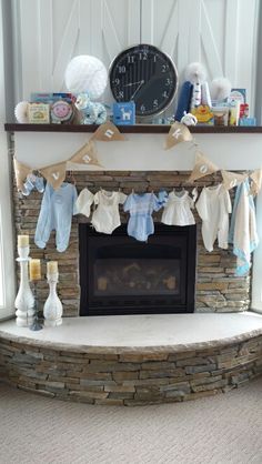 a fireplace with clothes hanging from it's mantle and a clock in the background