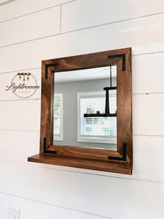 a mirror hanging on the side of a wall