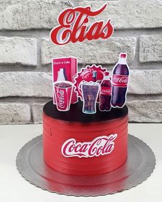 there is a cake with coca colas on the top and soda cans on the bottom