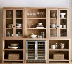 a wooden shelf filled with dishes and glasses