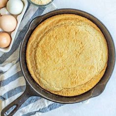 a pan filled with cake next to eggs