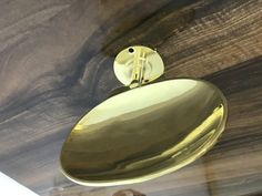 a close up of a light fixture on a wooden ceiling with wood grain in the background