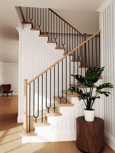 a potted plant sitting on top of a wooden table next to a stair case