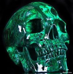 a green marbled skull is shown against a black background