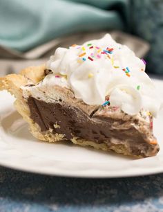 a slice of chocolate ice cream pie with sprinkles on a white plate