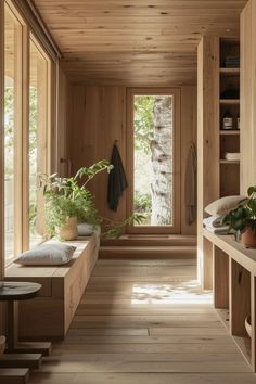 a long wooden hallway with plants and potted plants