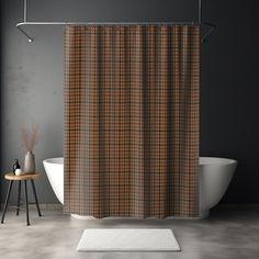 a bathroom with a bathtub, rug and shower curtain that has a brown plaid pattern on it