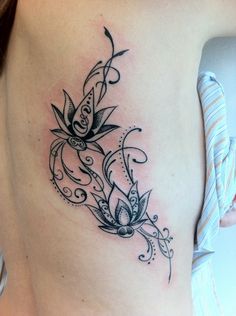 a woman's stomach with a tattoo design on it