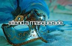 a masquerade mask with blue feathers and words written on the side that reads, attend a masquerade