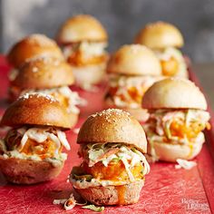 small sandwiches are lined up on a red tray