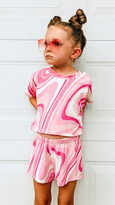 This beautiful groovy pink swirl outfit is sold as a set. Comes with a short sleeved  crop top and a pair of breezy shorts. Made with soft and stretchy yummy rib knit fabric that is so comfy for your girl to wear all summer long!  ➡️If you would like a custom length tee and not a cropped tee, please choose "Custom Size" and in the notes section at checkout, please provide me with the length of the tee that you want from the center back neck down to the hem.  Sizes are: XSmall (6-12mo) Small (12- Cute Matching Set Tops For Vacation, Pink Relaxed Fit Trendy Sets, Trendy Pink Relaxed Fit Sets, Playful Short Tops For Spring, Spring Playwear Short-sleeved Tops, Casual Pink Short Set With Relaxed Fit, Cute Short Pink Top, Casual Pink Relaxed Fit Short Set, Spring Matching Set Tops For Playwear