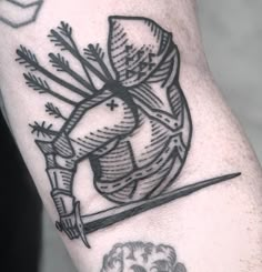 a tattoo on the arm of a man with an arrow and bow in it's center