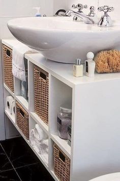 a white sink sitting on top of a cabinet next to a toilet and bathtub