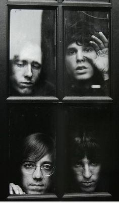 the doors are open to show three men looking out from behind them in front of a door