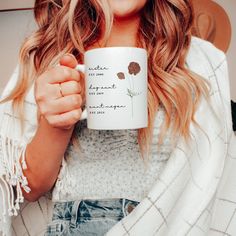 a woman holding a coffee mug in her hands