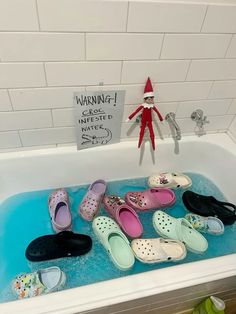 the elf is in the bathtub with many pairs of shoes