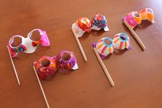 four candy lollipops are sitting on a table