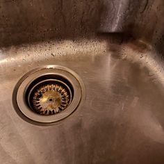 a stainless steel sink with water running down the drain