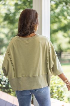 Mineral washed olive green french terry knit pullover top with hi-low bottom hem Sass up your casual attire with our Sunset Ready Washed Olive Top! This fun, comfy top features french terry knit fabric, wide 3/4 length sleeves, and a split hi-low bottom hem. Perfect for adding a quirky twist to any casual day out! Relaxed fit; semi-cropped Model is 5'5" wearing a small Fabric contains stretch Ribbed distressed crew neckline Wide 3/4 length sleeves with drop shoulder Front side slits and distress Oversized French Terry Tops For Layering, Casual French Terry Tops For Layering, Trendy Soft-washed French Terry Tops, French Terry Tops For Everyday Spring Wear, Casual French Terry Top With Drop Shoulder, Oversized Cropped Top For Loungewear, Casual French Terry Drop Shoulder Tops, Spring Khaki Tops For Loungewear, Oversized French Terry Top For Spring