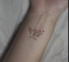 a person's arm with a tattoo on it that says love and two hearts