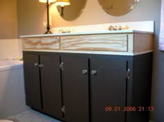 a bathroom with two sinks and mirrors on the wall