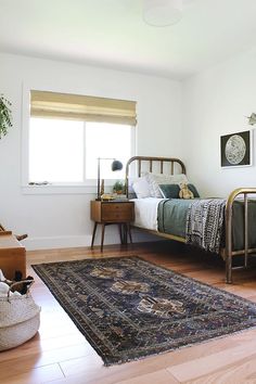 a bedroom with a bed and rug in it