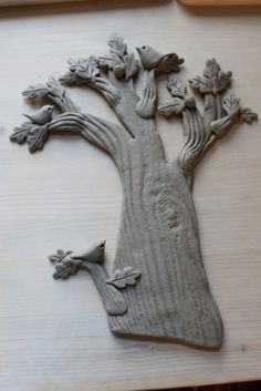 a carving of a tree with leaves on it