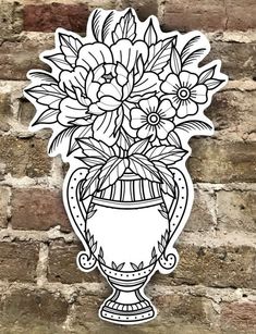 a sticker with flowers in a vase on a brick wall