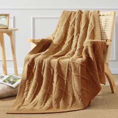 a brown blanket sitting on top of a wooden chair