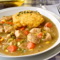 a white plate topped with chicken and vegetable soup