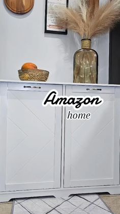 an amazon home logo is shown on the side of a white cabinet with doors and drawers