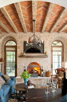 a living room filled with furniture and a fire place under a tv mounted above a fireplace