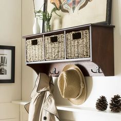 a coat rack with baskets and hats on it