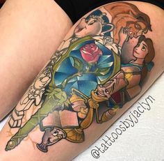 a woman's leg with an image of the characters from beauty and the beast on it