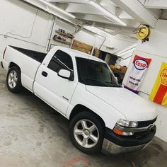 a white pick up truck parked in a garage