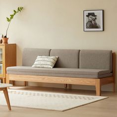 a living room with a couch, coffee table and bookshelf on the wall