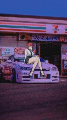 a woman is sitting on the hood of a car in front of a convenience store