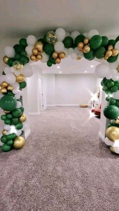 an arch made out of balloons in the shape of shamrocks and gold foil balls