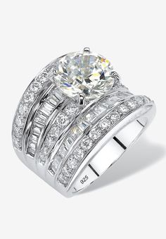 Our cubic zirconia concave ring is a whopping 7.14 glistening tower of sparkling stones. The center round is accented with a bold but elegant design of multi-row baguettes and rounds. This will light up not only her hand, but the entire room. Set in platinum over .925 sterling silver. Sizes 5-9.  Main Stone: 1 Round Faceted Cut Cubic Zirconia, 4 carats, 10 mm x 10 mm10 Baguette Step Top Cut Cubic Zirconias, .8 carats total weight, 2.5 mm x 2 mm12 Baguette Step Top Cut Cubic Zirconias, .6 carats Cubic Zirconia Engagement Rings Jtv, Luxury Wide Band Cubic Zirconia Ring, Round Engagement Ring, Silver Jewellery Online, Cubic Zirconia Engagement Rings, Silver Engagement Ring, Round Engagement Rings, Cubic Zirconia Jewelry, Engagement Ring Sizes