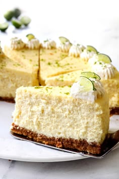 a piece of cheesecake with cucumber on top sits on a white plate