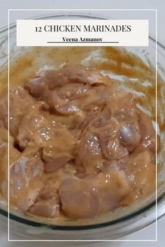 a glass bowl filled with meat and gravy on top of a white table