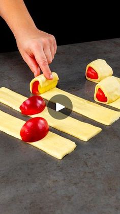 someone is making some food out of pasta and apple slices on the table with one hand