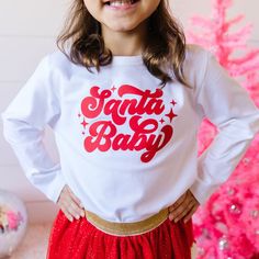 The Santa Baby Red Christmas Long Sleeve Shirt is a fun and festive shirt for kids celebrating Christmas! Features: Shirt Color: White Graphic Color: Red Material: 95% Cotton/5% Spandex Features: Tagless inside neck label for an itch-free wear Fit: Toddler Unisex; True to Size Care: Machine washable, tumble dry low Each shirt is hand pressed with love using baby and child safe inks. Christmas Loungewear, Christmas Long Sleeve Shirts, Girls Halloween Outfits, Leotard Tops, Baby Red, Girls Holiday Dresses, Girls Easter Dresses, Gymnastics Outfits, Celebrating Christmas