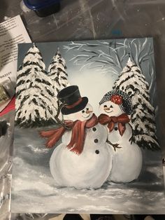 a painting of two snowmen standing next to each other in front of some trees