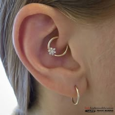 a close up of a person's ear with a piercing