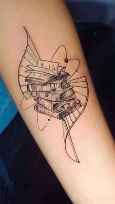 a woman's arm with a tattoo on it that has books in the shape of a butterfly