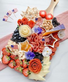 a heart shaped platter filled with fruit and veggies